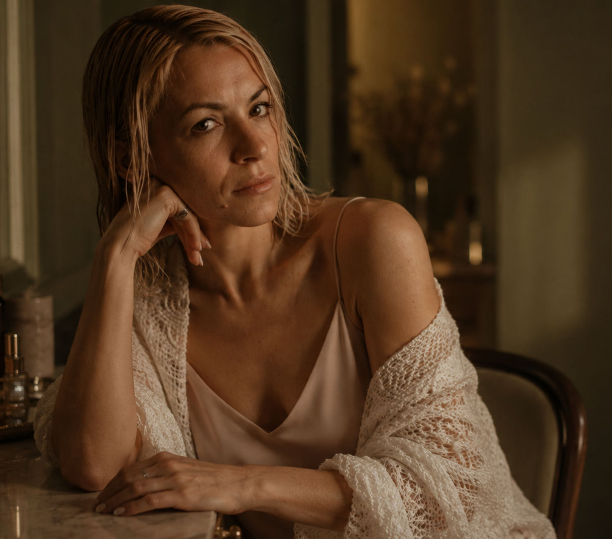 A woman in a warm, dimly lit interior 