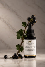 A small dropper bottle labeled White Turtle Beauty Beloved 
