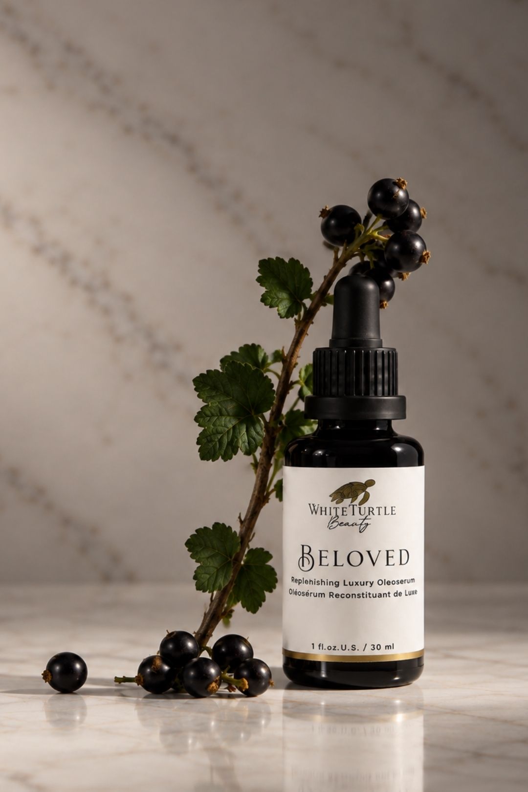A small dropper bottle labeled White Turtle Beauty Beloved 
