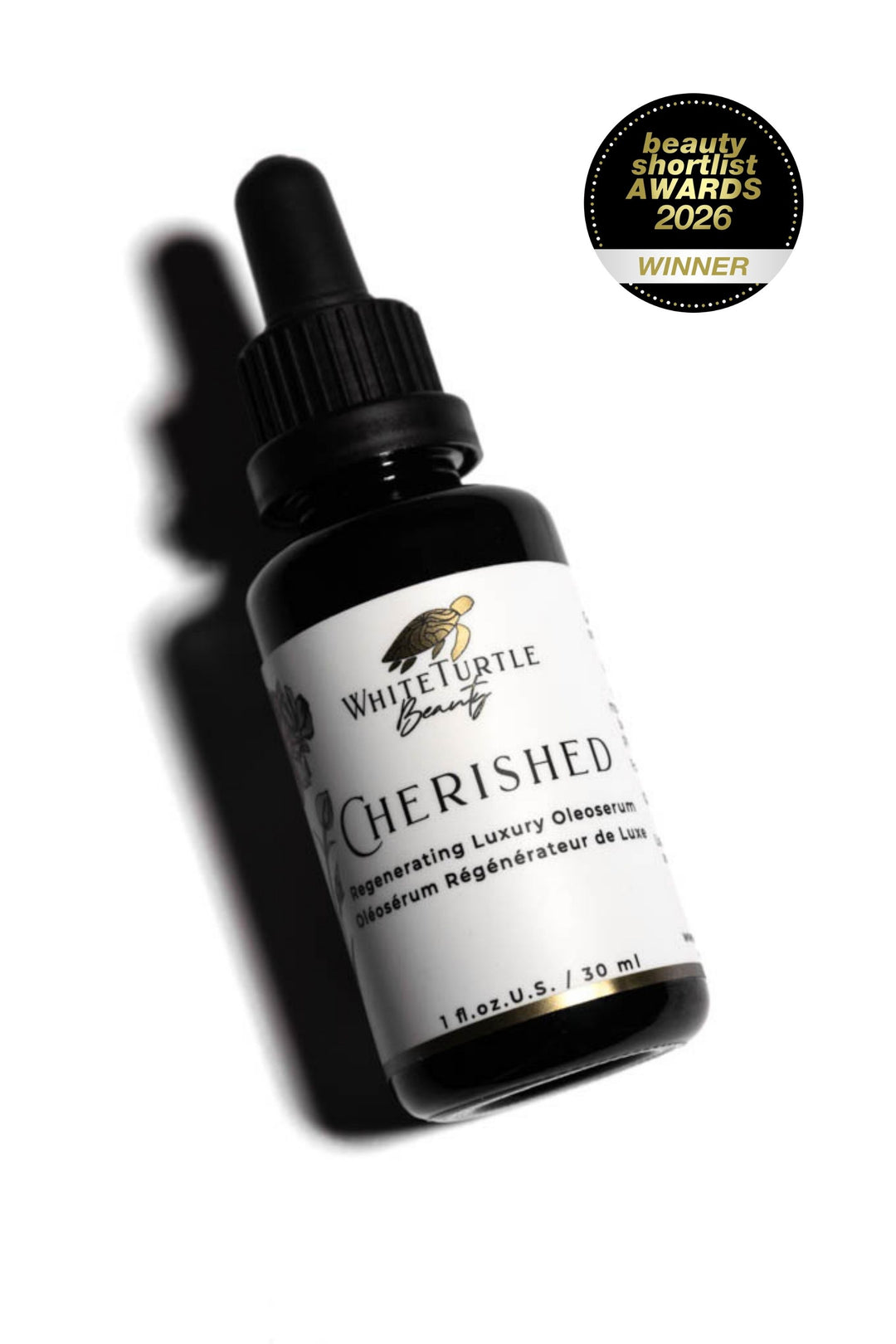 Black bottle with dropper labeled 'Cherished' from White Turtle Beauty on a white background, with an award badge above.