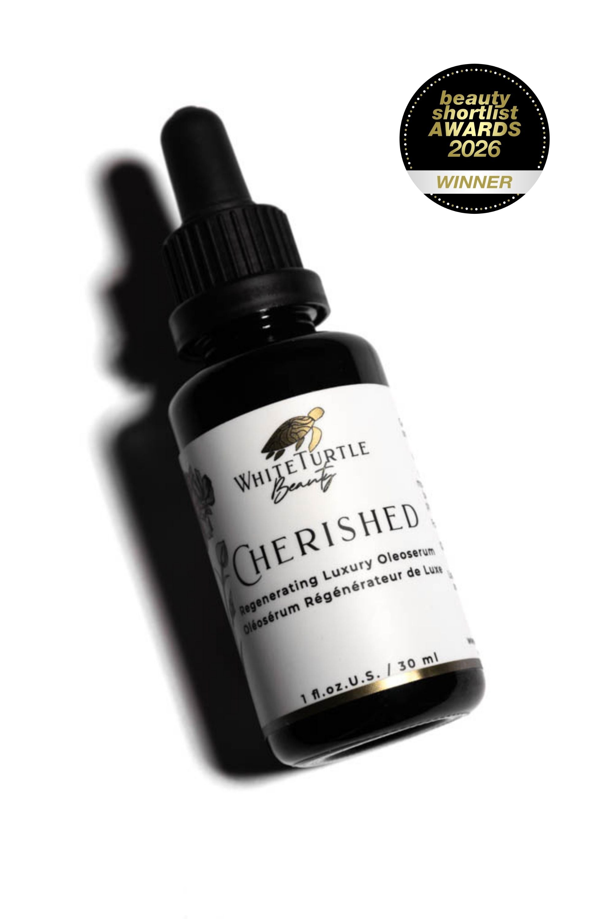 Black bottle with dropper labeled 'Cherished' from White Turtle Beauty on a white background, with an award badge above.