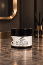 A jar of White Turtle Beauty Gorgeous 5-in-1 Concentrated Balm sits on a polished dark marble countertop i