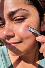 Woman massaging GORGEOUS 3-in-1 Balm for reactive and inflamed skin on face