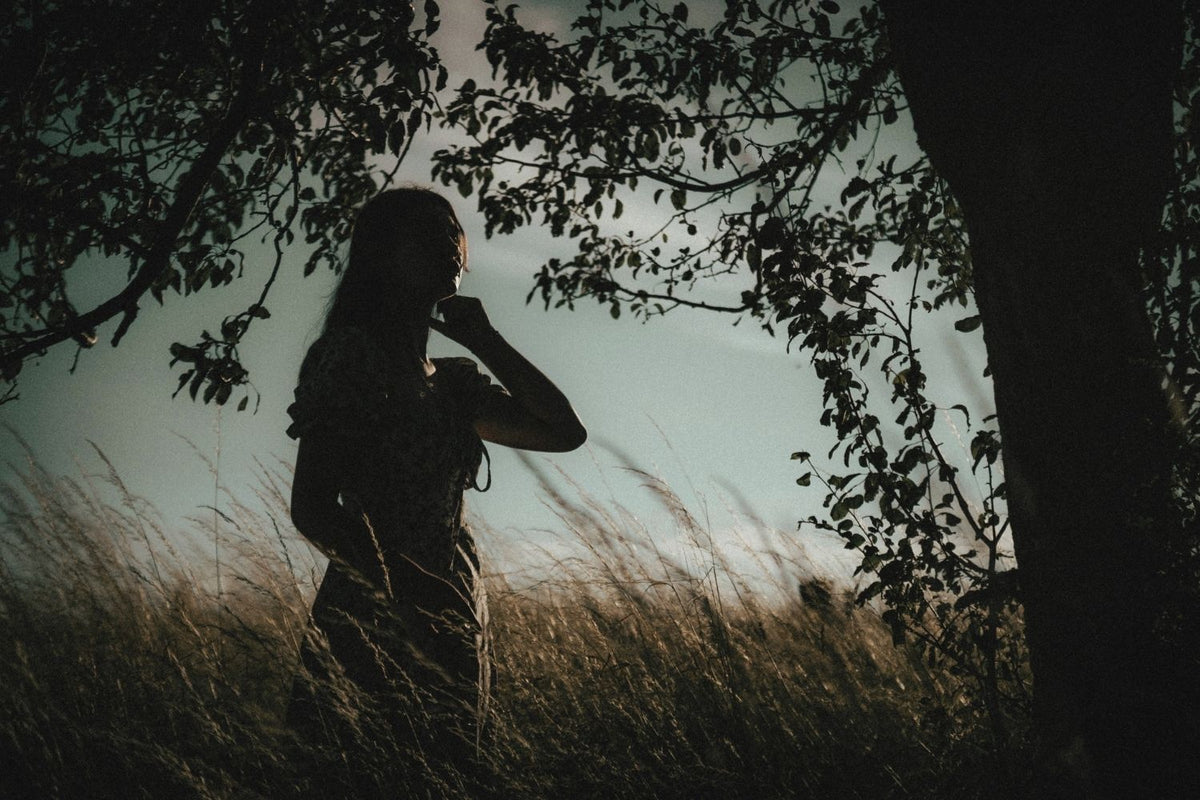 Woman moving slowly through nature in a grounding moment