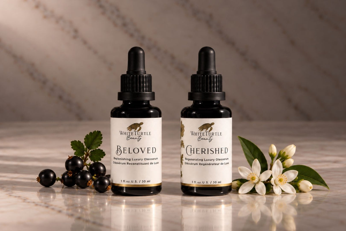 Two small white-and-black dropper bottles from White Turtle Beauty, labeled 'Beloved' and 'Cherished