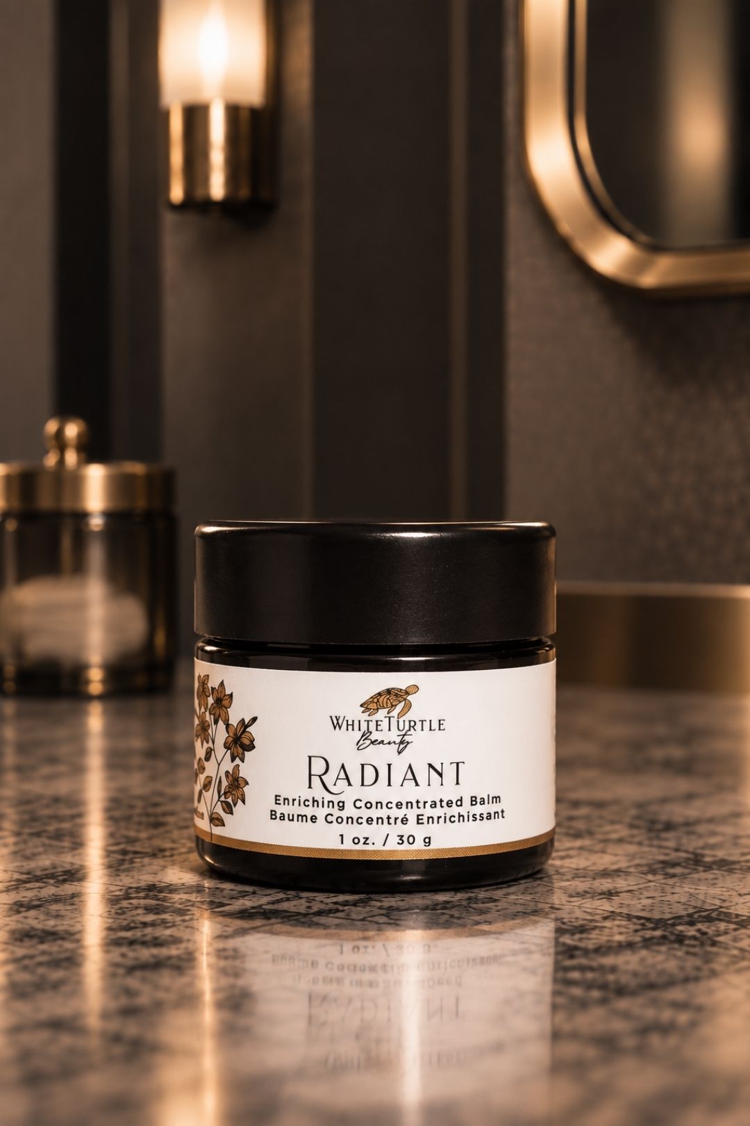 A jar of White Turtle Beauty Radiant Enriching Concentrated Balm sits on a polished dark marble countertop