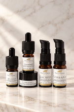 Four White Eagle skincare bottles and jars arranged on a light marble surface with a marble wall behind them.