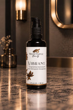 A bottle of White Turtle Beauty Vibrant Regenerating Cleansing Oil stands on a polished dark marble countertop 