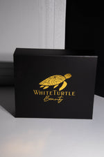 Black box with gold 'White Turtle Beauty' logo on a gray background