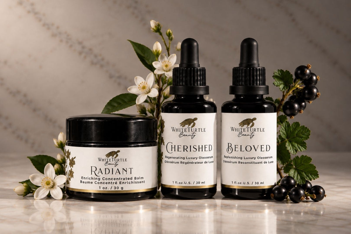 Three White Turtle Beauty skincare products arranged on a marble surface with botanical props