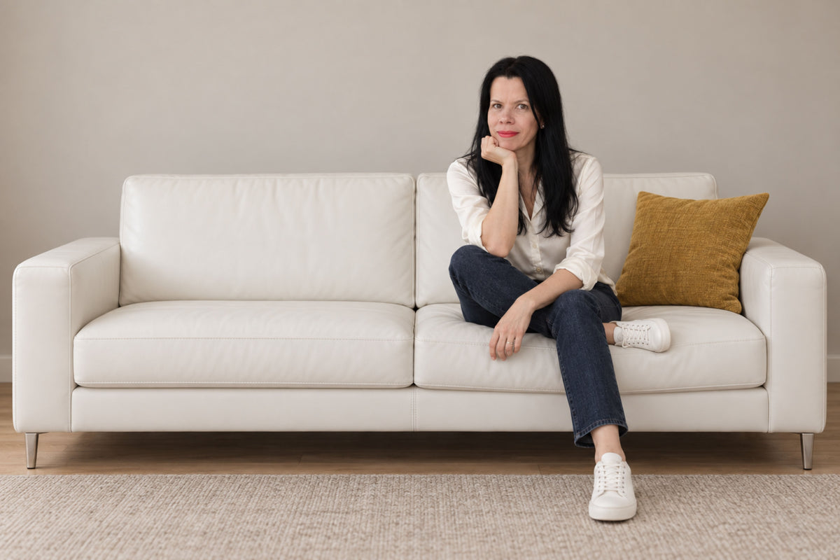 White Turtle Beauty founder sitting in modern white leather sofa
