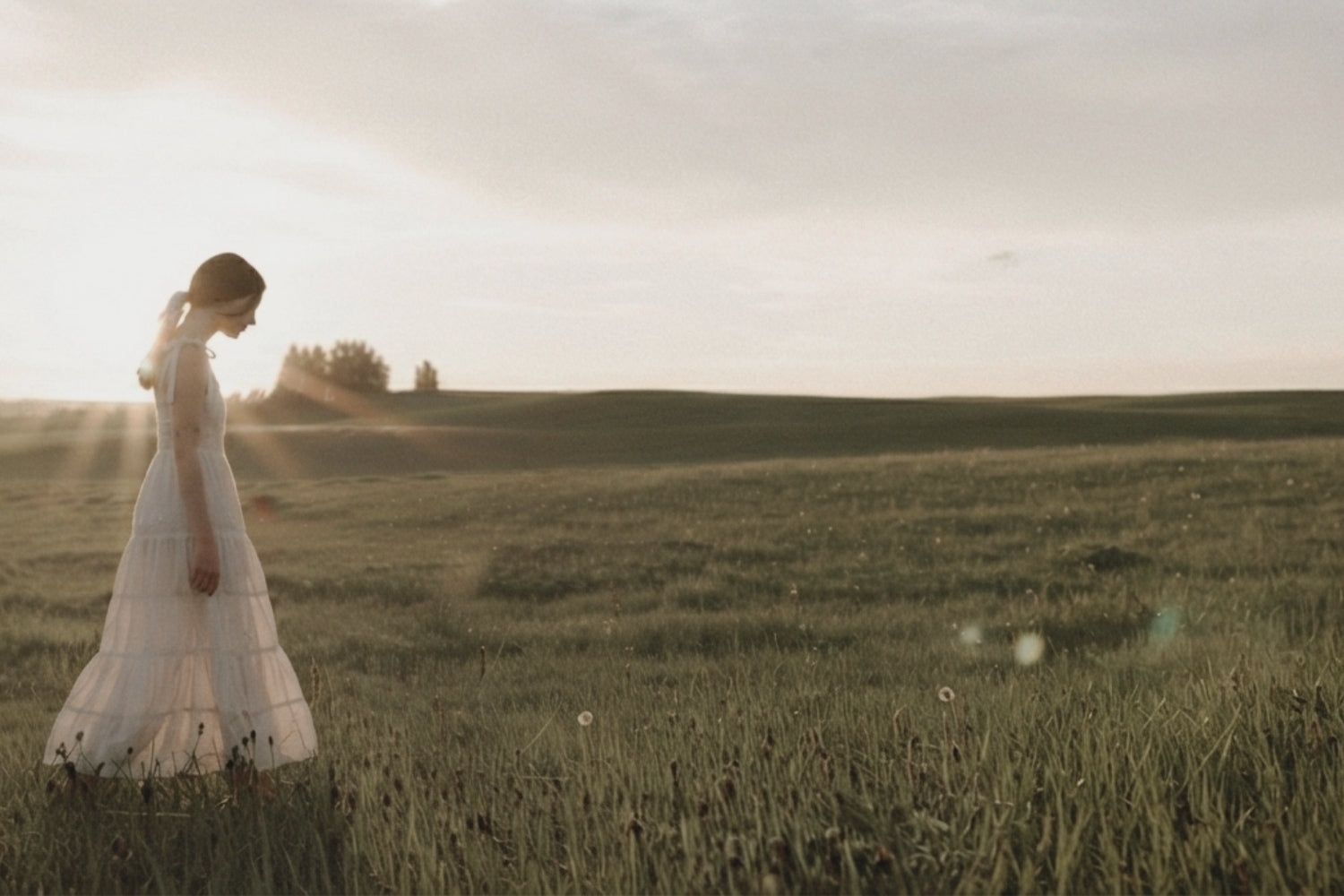 Woman enjoying grounding moment in a field