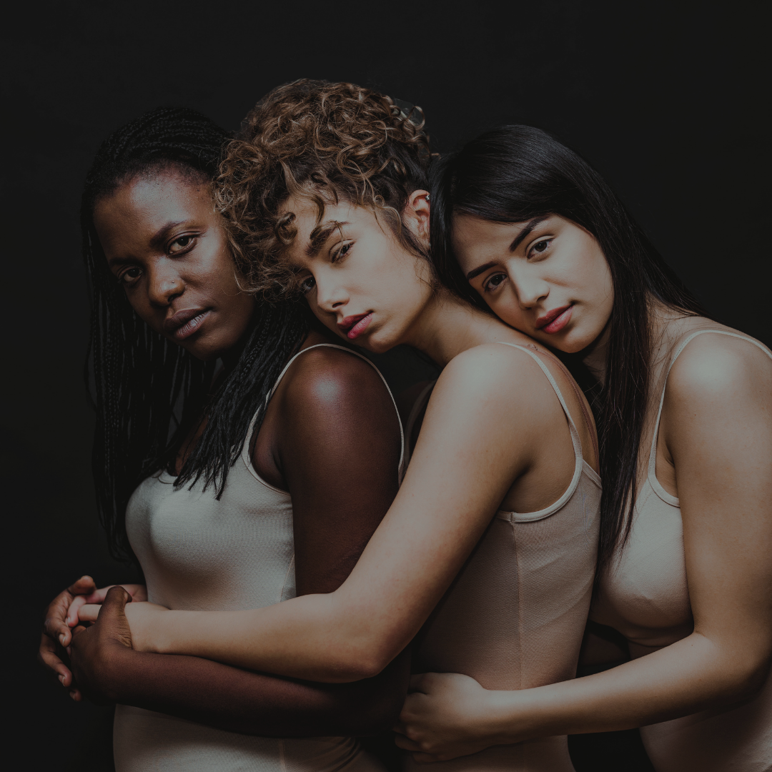Three women hugging closely 